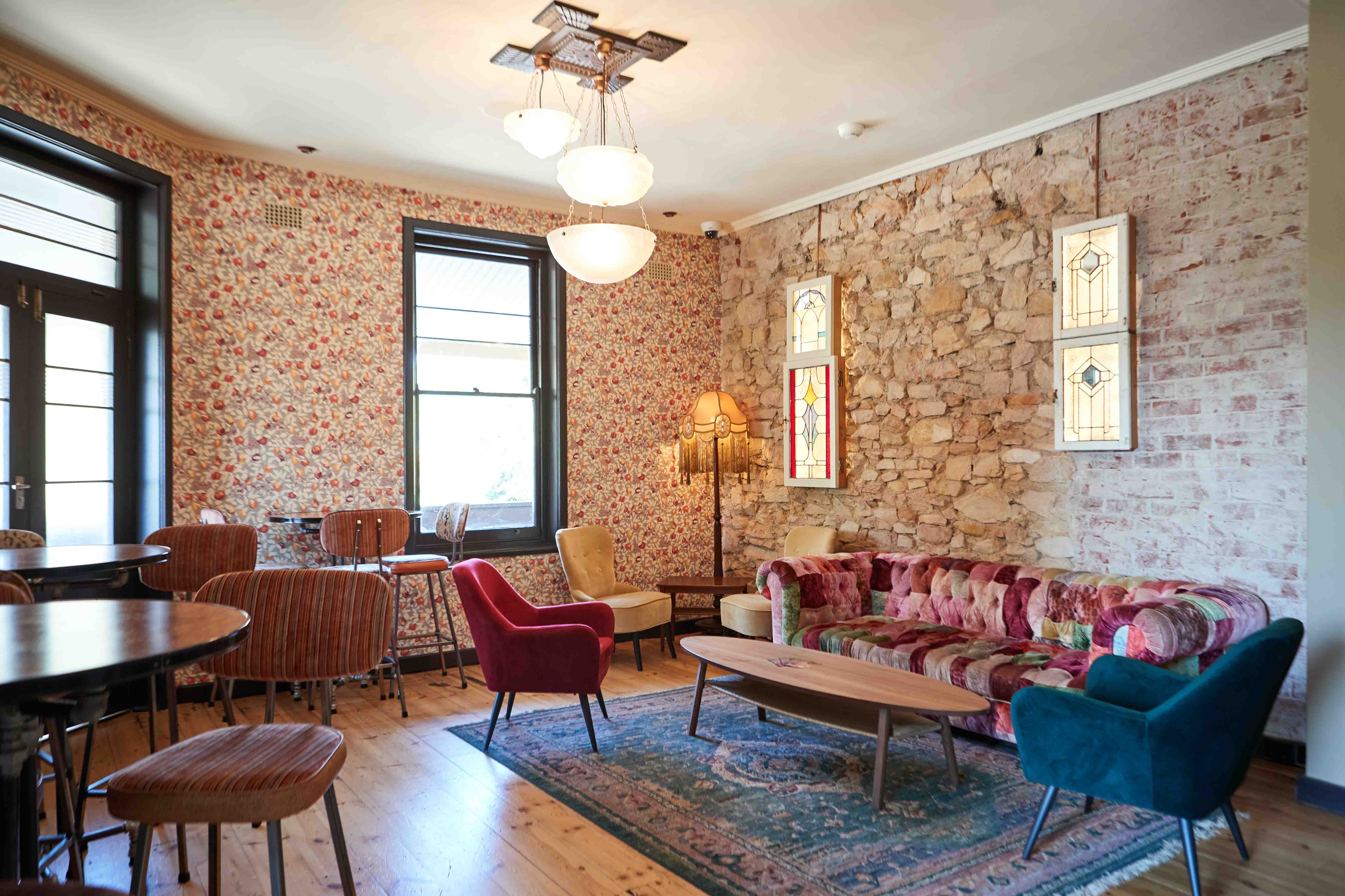 The Loft function room with lounge chairs, rugs and exposed stone walls