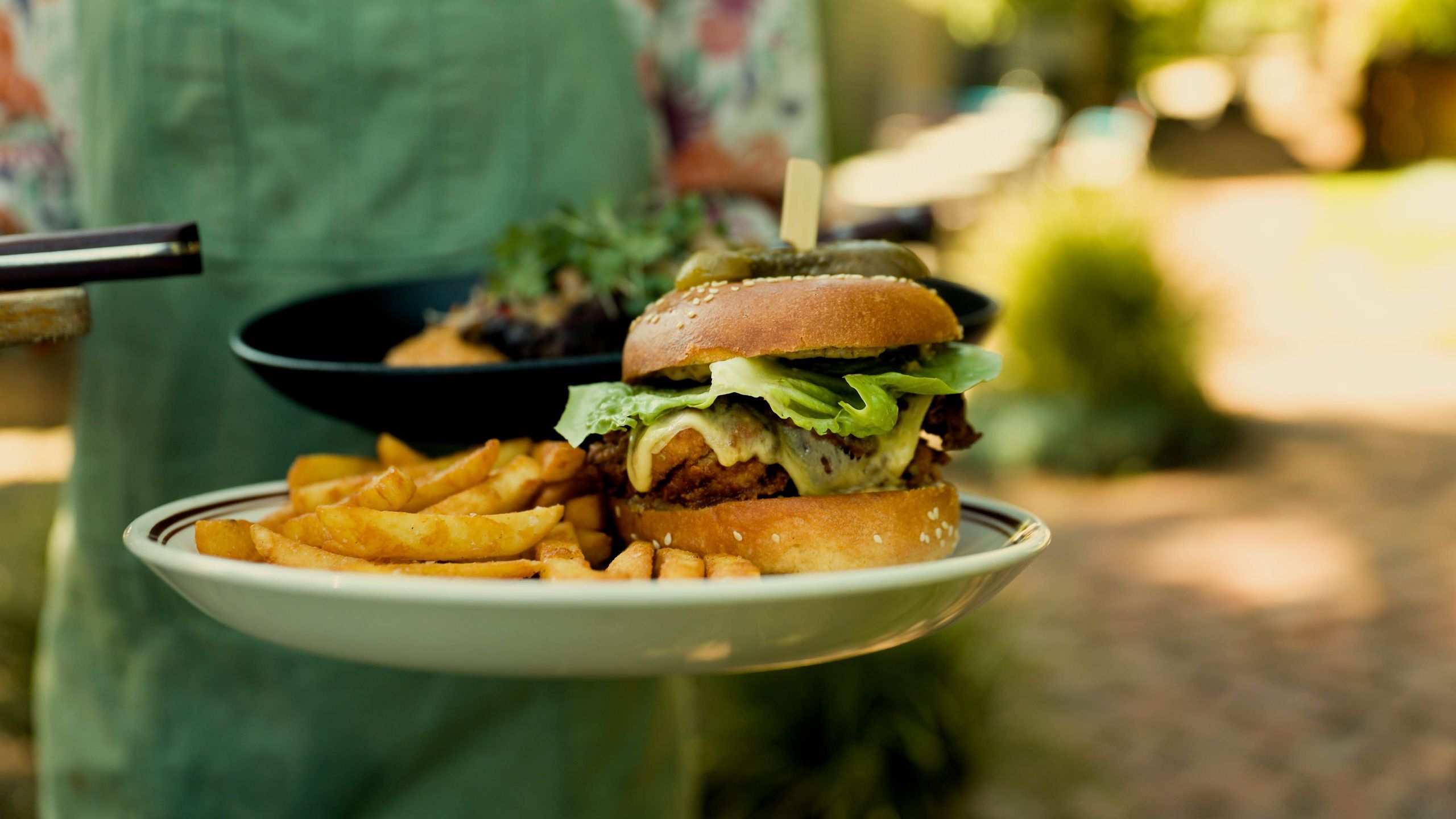 Burger and chips being served in the beer garden