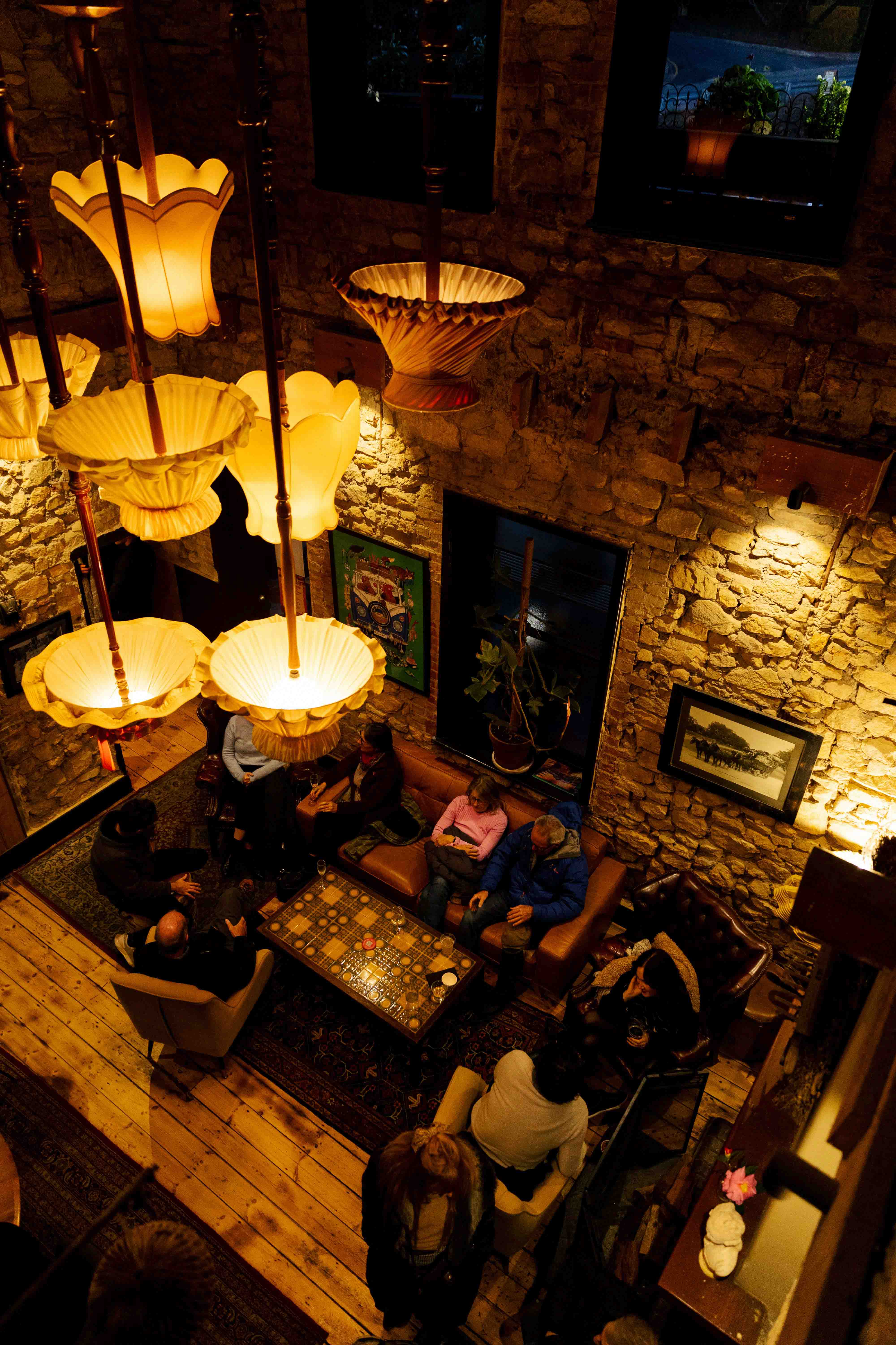 Dining room at night lit by vintage pendant lamps