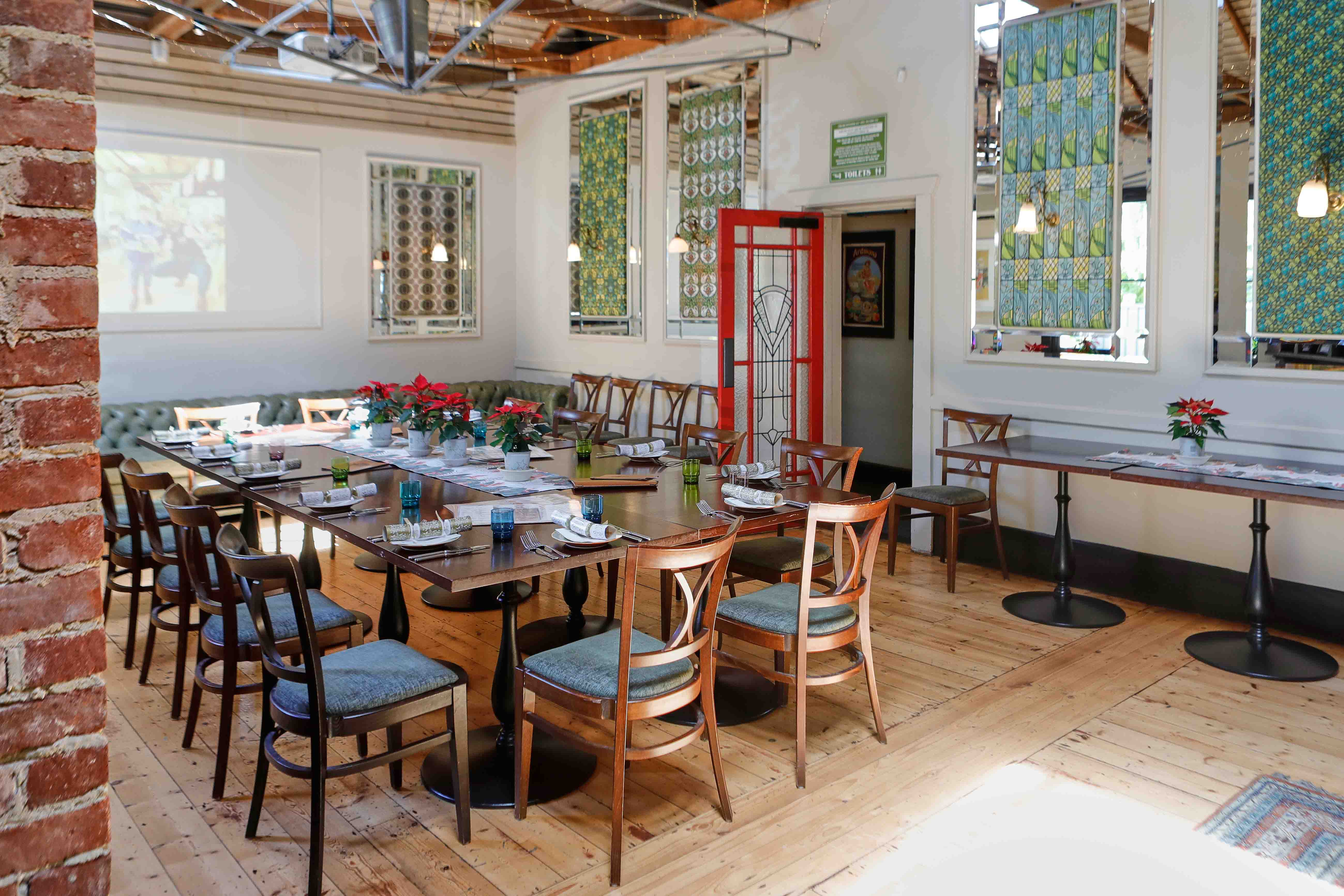 Dining room with timber floors and tables set for service